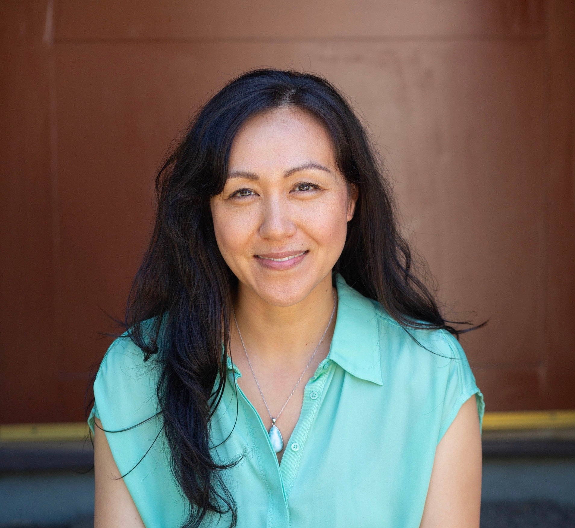 photo of Patty clinical herbalist and holistic beauty coach sitting on doorstep